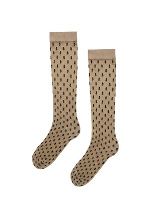 Beige doorzichtige kniekousen met zwarte bladmotieven en effen beige manchet bovenaan.