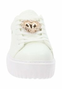 Zapatilla blanca con un exterior de piel lisa, que presenta un brillante adorno en forma de corazón dorado en los cordones y una suela gruesa blanca.