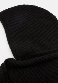 Beanie nero in maglia, con texture a costine e design ripiegato. Tessuto morbido che offre calore e conforto.
