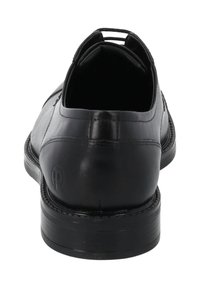 Scarpa da uomo in pelle nera con finitura liscia, punta arrotondata, cuciture sottili e tacco basso impilato. Include una linguetta nella parte posteriore.