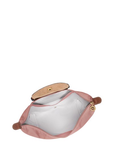 Pink fabric pouch with a smooth texture, leather accents, and a snap closure. Interior is lined in white. No external pockets visible.