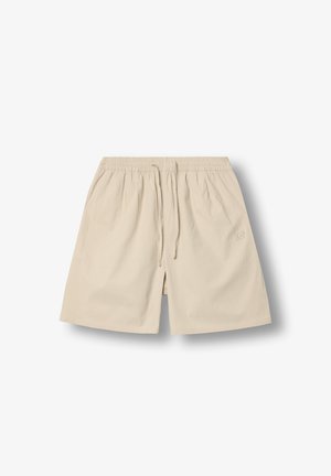 Beige knee-length shorts with elastic waistband and drawstring, textured fabric, and subtle embroidered logo on left thigh.