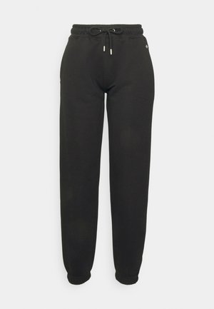 Pantaloni della tuta neri realizzati in tessuto morbido, con vita elastica e lacci, e polsini a coste alle caviglie. Design minimalista, senza fantasie.