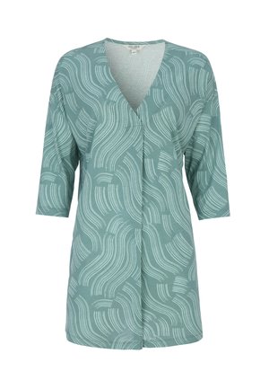 Grøn tunika med abstrakte hvide bøjede linjemønstre, 3/4-ærmer og V-hals.