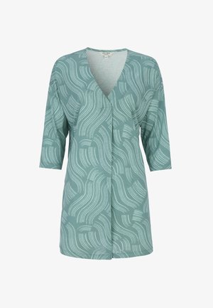 Grøn tunika med abstrakte hvide bøjede linjemønstre, 3/4-ærmer og V-hals.