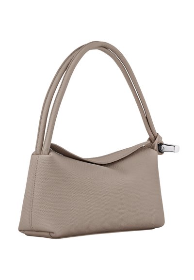 Beige textured leather handbag with two narrow handles, a zip closure, and a contoured shape. Features a smooth metal accent.