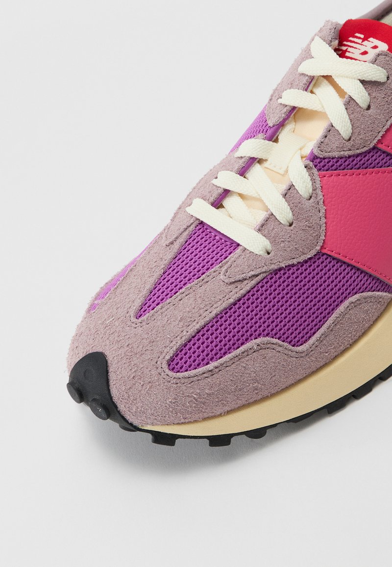 Chaussure de sport en mélange de daim violet et de mesh avec un accent en cuir rose, des lacets blancs et une semelle en caoutchouc noir.