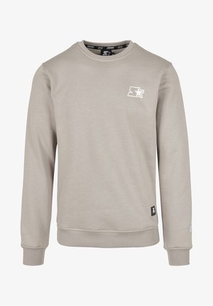 Lys grå sweatshirt med rund halsudskæring og lange ærmer. Har et lille hvidt stjernelogo på brystet samt ribbede manchetter og kant.