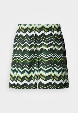 Zigzag mintájú úszónadrág zöld, fekete és fehér árnyalatokban. Könnyű anyagból készült, rugalmas derékrésszel.