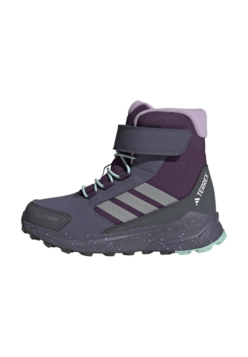 Purple mid-top hiking boots with gray accents, Velcro strap, textured surfaces, and a speckled sole. Suitable for outdoor activities.