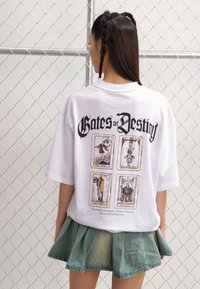 T-shirt alb supradimensionat, cu textul "Porțile Destinului" și patru modele de cărți de tarot afișate pe spate, cu un decolteu rotund.