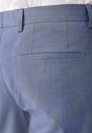 Light blue trousers featuring a diagonal texture, a back pocket with a flap, and a smooth waistband design. Tailored fit evident.