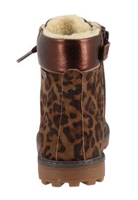 Leopard print ankle boot with a brown suede exterior, metallic bronze trim, cozy shearling lining, and rugged rubber sole for traction.