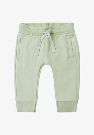 Pantalons de survêtement vert clair avec des poignets et une taille côtelés, fermeture à cordon de serrage, et deux poches latérales. Tissu doux à la texture lisse.