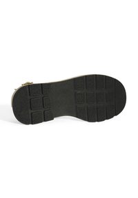 Zwarte rubberen schoenzool met een gestructureerd oppervlak, voorzien van een rasterpatroon van rechthoekige profielstukken voor grip en duurzaamheid.