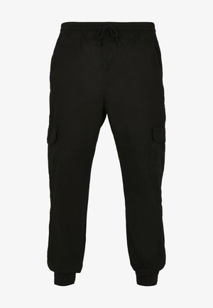 Mustad mustad püksid pehmest kangast, millel on elastne vöökoht ja köit, küljetaskud ja kitsenevad sääred.