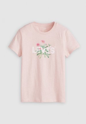 Lys rosa bomull t-skjorte med rund halslinning. Har et blomsterdesign og ordet "LEVI'S" i fet hvit tekst over forsiden.