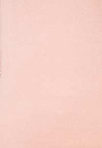 Light pink knit fabric with a smooth texture and ribbed pattern, suitable for clothing or textile applications. No visible patterns or accents.
