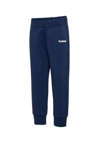 Granatowe dresy wykonane z miękkiego materiału, z elastycznym paskiem w talii, z prążkowanymi mankietami i białym logo "hummel" na lewej nodze.