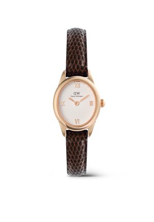 Rose gold oval watch with white textured dial, Roman numerals at 3, 6, 9, 12, and dark brown textured leather strap.