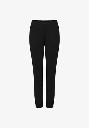 Czarne dresy z elastycznym paskiem w talii, zwężającą się nogawką i ściągaczami na kostkach. Wykonane z miękkiego, rozciągliwego materiału.