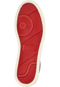 Suela de zapato de goma con una superficie roja, con círculos concéntricos y ranuras horizontales, bordeada por un borde blanco apagado, marcada con el tamaño 42.