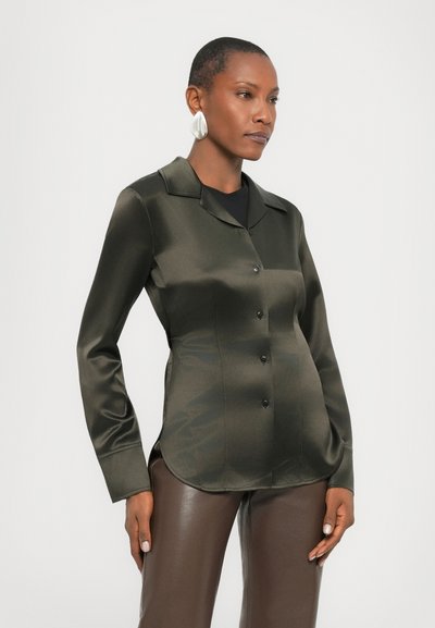 Dark green satin blouse with a collar, button front, and fitted design. Long sleeves and smooth texture enhance the polished appearance.