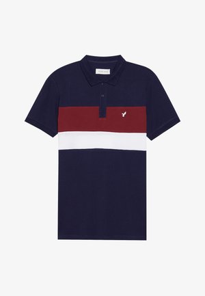 Navy blue polo shirt with a red and white horizontal stripe. Features a buttoned collar and a small white bird logo on the chest. Cotton material.