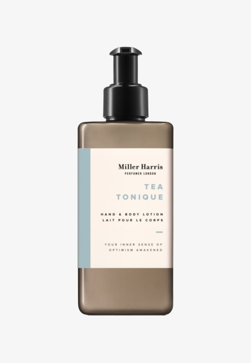 Braune Flasche mit einer Pumpen-Spender, versehen mit einem hellblauen Etikett. Der Text weist darauf hin, dass es sich um "Tea Tonique" Hand- und Körperlotion handelt.