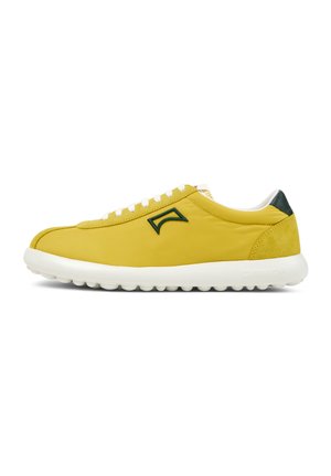 Yellow sneaker with a smooth, textured leather upper, white laces, green accents, and a cushioned white sole featuring a rounded shape.