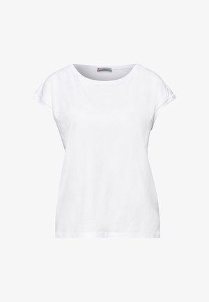 Haut décontracté blanc à manches courtes pour femme avec un col rond et une coupe ample, montrant l'étiquette intérieure "Street One."