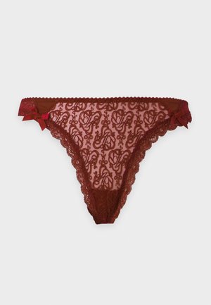 Sous-vêtements féminins en dentelle rouge avec motifs floraux, bords festonnés et petits nœuds en satin sur chaque hanche.