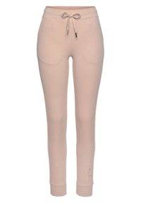 Helle rosa Jogginghosen mit einem Kordelzugbund, zwei Seitentaschen und gerippten Bündchen. Das Material wirkt weich und bequem mit einer glatten Textur.