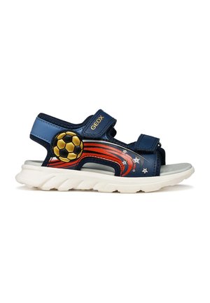 Sandalo bambino blu navy con suola bianca, design di stella cadente rossa e arancione, dettaglio pallone da calcio oro e nero e due cinturini in velcro.