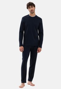 Navy blue loungewear set made of soft fabric, featuring a long-sleeve crew neck top and matching pants with elastic waistband.