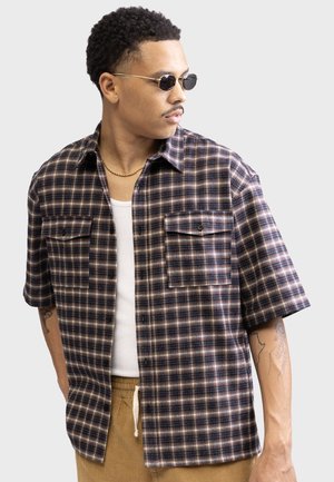 Short-sleeve plaid shirt in dark navy, burgundy, and beige. Features two chest pockets, button-up front, and a relaxed fit. Cotton blend fabric.
