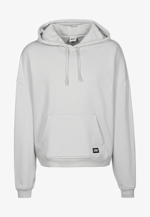 Lys grå hoodie med en frontlomme, snørelukning i hætten og ribbede manchetter og bund. Fremstillet af blødt, tekstureret stof med en afslappet pasform.