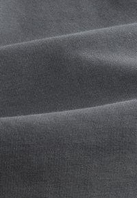 Gray fabric with a smooth, ribbed texture, featuring subtle variations in shading and a medium stretch characteristic.
