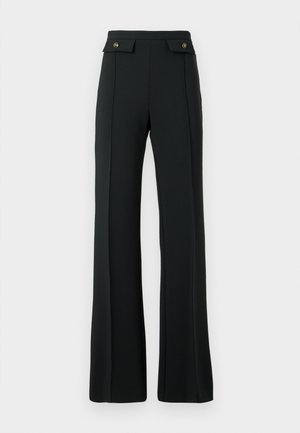 High-waisted black flared trousers with front seam details and two gold-buttoned flap pockets at the waist.