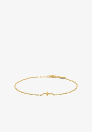 Bracelet chaîne en or délicat avec un petit pendentif en forme de croix au centre et une fermeture à mousqueton sur fond blanc.