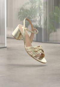 Neselectat, gold-coloured