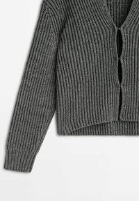 Cardigan gris côtelé en maille avec manches longues et trois fermetures à boutons à boucle sur le devant, présenté sur fond blanc.