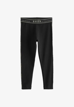 Zwarte leggings van rekbaar materiaal met een gouden logo aan de zijkant en een brede tailleband, met een gladde textuur.