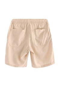 Beiga shorts i lätt tyg, med elastisk midja och två bakfickor, med en enkel och ren design.