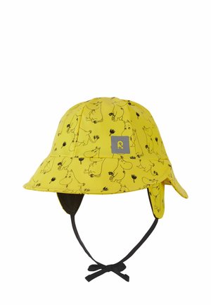 Żółty dziecięcy kapelusz typu bucket z czarnym wzorem kreskówkowego zwierzęcia, nausznikami i wiązanym paskiem pod brodą.