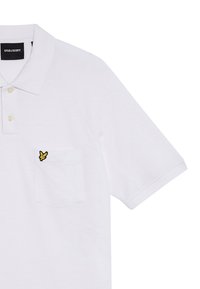 Hvid polo shirt lavet af glat bomuld med en tre-knaps placket. Har en lomme med et gult broderet logo på venstre side.
