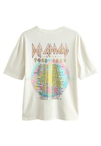 White cotton t-shirt featuring a colorful graphic design with "Def Leppard Tour 1983" text and a list of cities on the back.