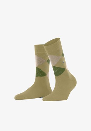 Chaussettes mi-mollet de couleur vert olive avec un motif argyle géométrique en beige clair et vert, agrémentées de discrètes surpiqûres bleues.