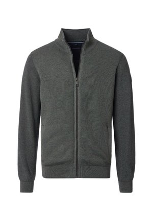 Veste zippée vert foncé avec col montant, texture côtelée, manches longues et poches latérales. Elle est dotée d'une fermeture éclair lisse et de poignets ajustés.