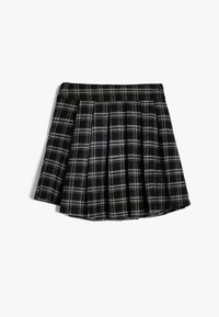 Gonna mini in bianco e nero a quadri con pieghe, con una vita aderente e un tessuto morbido e strutturato.
